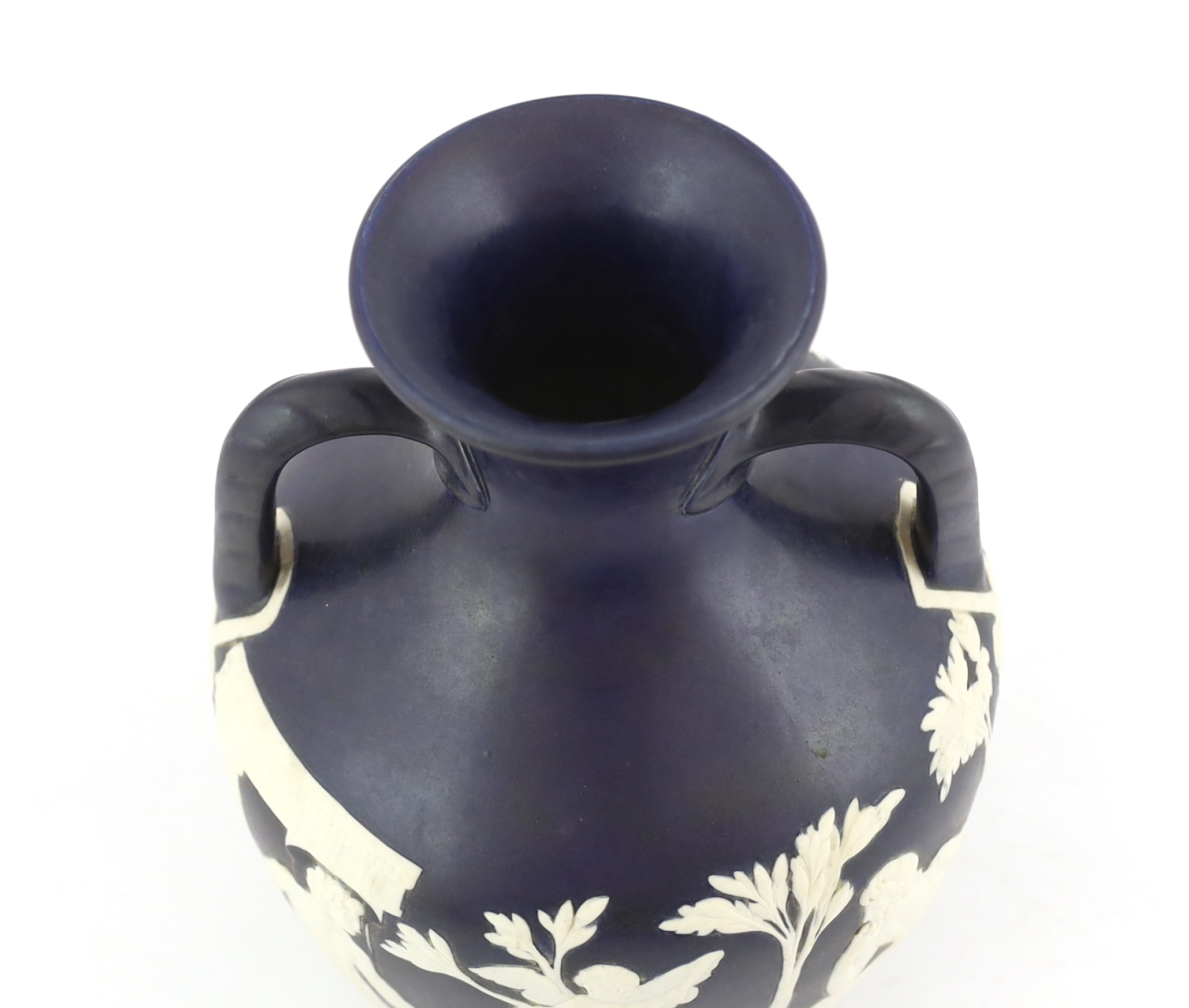 A Wedgwood dark blue glazed and white sprigged replica of the Portland vase, late 19th century